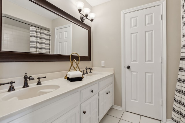 bathroom featuring tile patterned flooring, double vanity, and a sink