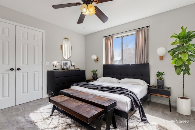 carpeted bedroom featuring a closet and ceiling fan