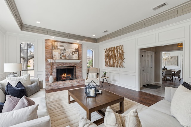 living area with a decorative wall, plenty of natural light, and visible vents