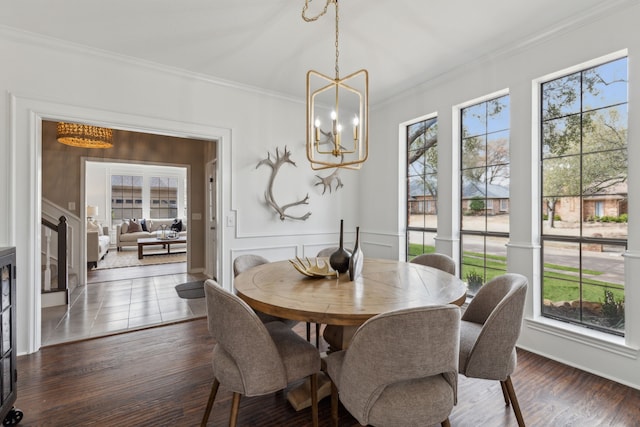 dining area with a notable chandelier, dark wood-style floors, and crown molding