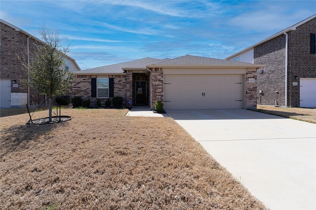 ranch-style home featuring brick siding, an attached garage, concrete driveway, and a front lawn