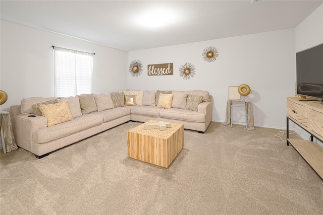living area featuring baseboards and light carpet