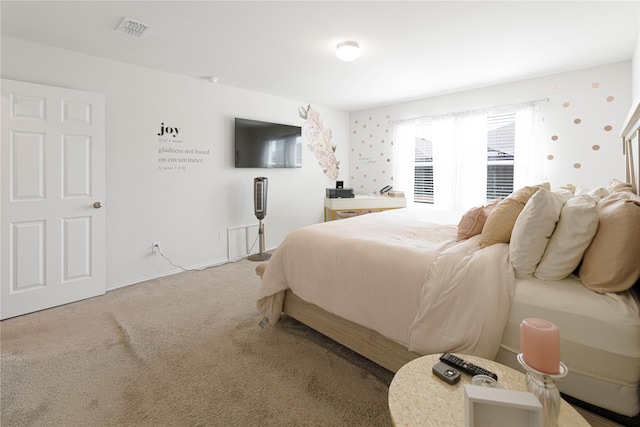 carpeted bedroom featuring visible vents