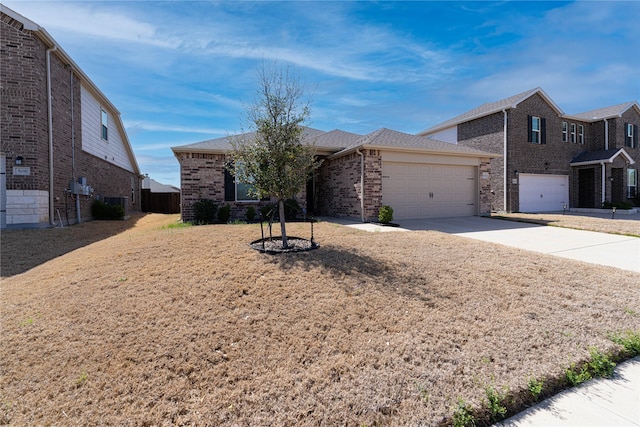 ranch-style house with cooling unit, brick siding, concrete driveway, and an attached garage