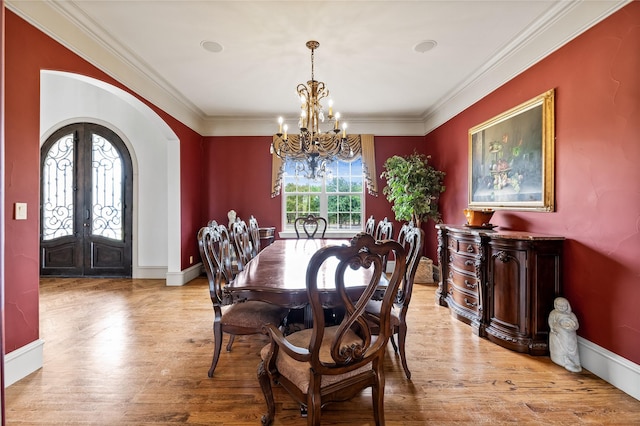 2933 N Star Dr, Celina, TX 75009 - dining space with ornamental molding, french doors, wood finished floors, arched walkways, and a notable chandelier