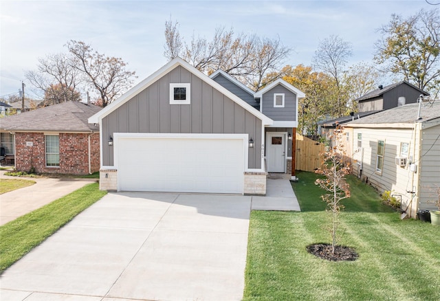 4011 Puget St, Dallas, TX 75212 - view of front of home featuring board and batten siding, a garage, driveway, and brick siding