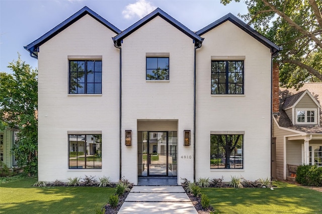 4910 W Hanover Ave, Dallas, TX 75209 - view of front of home with brick siding and a front lawn