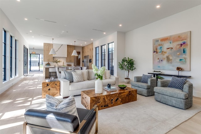 4910 W Hanover Ave, Dallas, TX 75209 - living room with light wood-style floors, recessed lighting, and baseboards