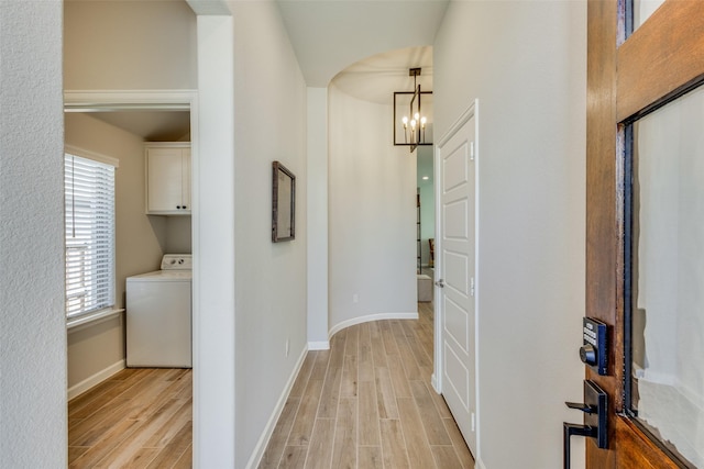 3136 Brazoria Dr, Little Elm, TX 75068 - corridor with baseboards, light wood-style floors, washer / clothes dryer, and a chandelier