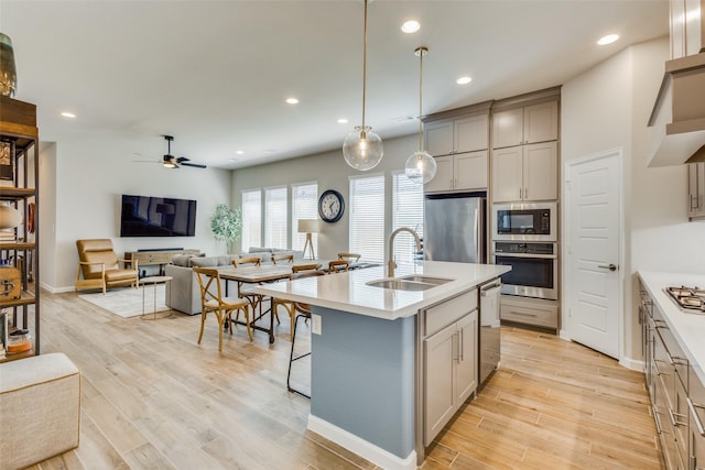3136 Brazoria Dr, Little Elm, TX 75068 - kitchen featuring ceiling fan, a sink, open floor plan, light countertops, and appliances with stainless steel finishes
