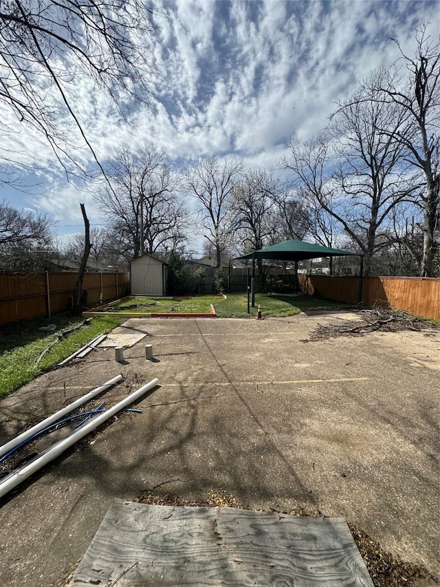3023 Arizona, Dallas, TX 75216 - view of yard featuring a storage unit, a fenced backyard, a carport, and an outdoor structure
