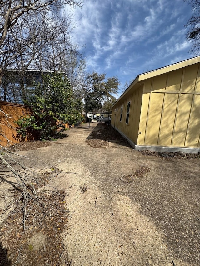 3023 Arizona, Dallas, TX 75216 - view of side of property with board and batten siding and fence
