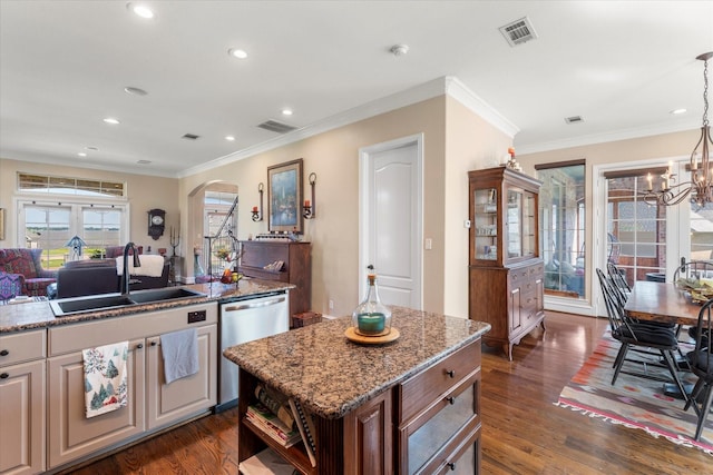 kitchen with visible vents, a sink, dark wood finished floors, arched walkways, and dishwasher