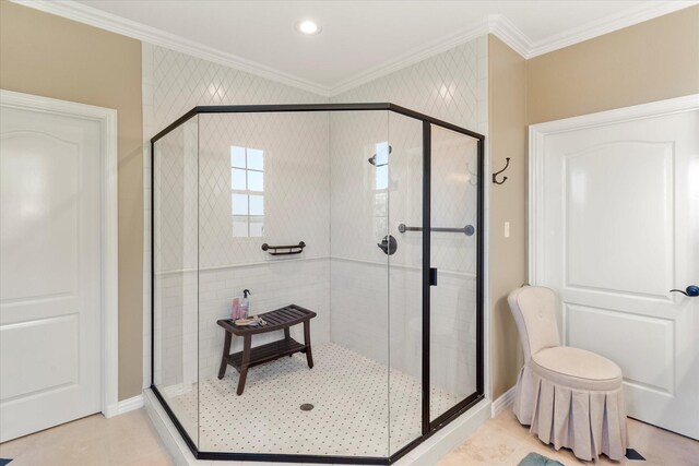 bathroom with a stall shower, ornamental molding, and tile patterned floors