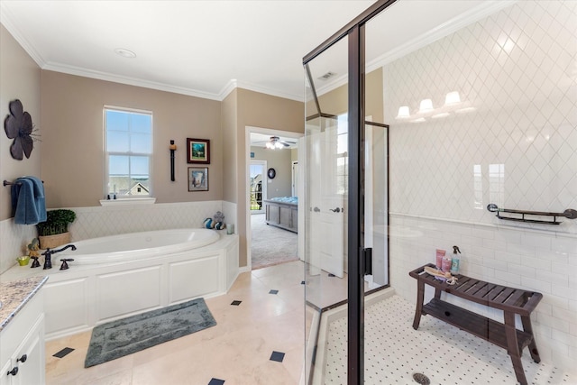 bathroom with a stall shower, tile walls, crown molding, a healthy amount of sunlight, and a bath