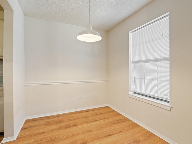 218 N Texas Blvd Unit 316, Denton, TX 76201 - empty room with a textured ceiling, baseboards, and wood finished floors