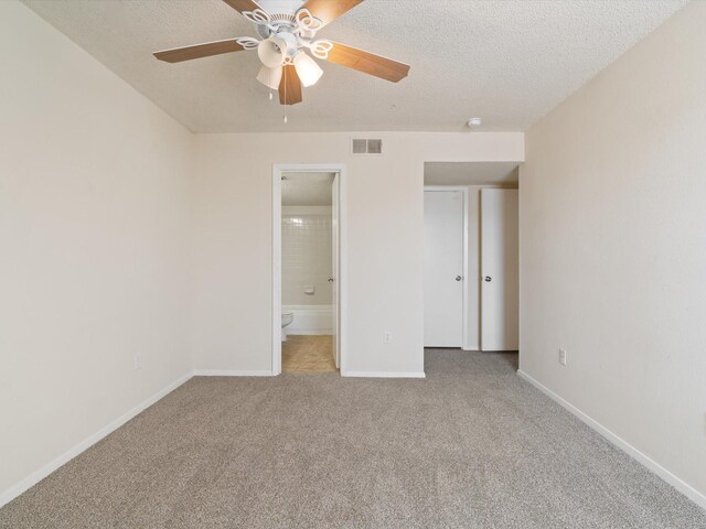 218 N Texas Blvd Unit 316, Denton, TX 76201 - unfurnished bedroom featuring baseboards, visible vents, carpet floors, ensuite bathroom, and a textured ceiling