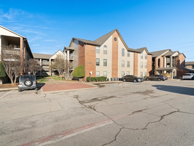 218 N Texas Blvd Unit 316, Denton, TX 76201 - view of building exterior featuring a residential view and uncovered parking