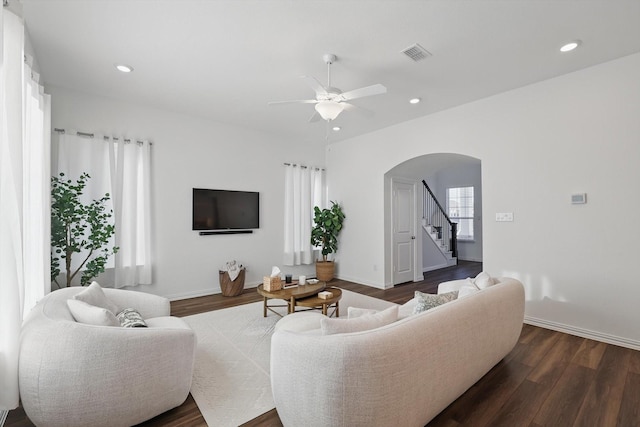 1417 Horizon Way, Northlake, TX 76247 - living area featuring a ceiling fan, visible vents, stairway, arched walkways, and dark wood-style floors