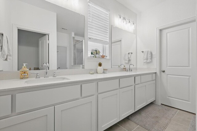 1417 Horizon Way, Northlake, TX 76247 - bathroom featuring tile patterned floors, a shower with door, double vanity, and a sink