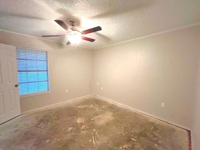 spare room featuring a textured ceiling, concrete floors, and ceiling fan