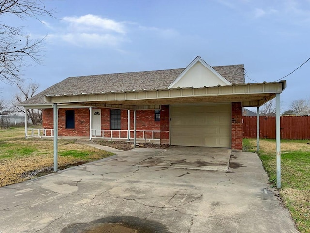 view of front of home featuring fence, covered porch, concrete driveway, an attached garage, and brick siding