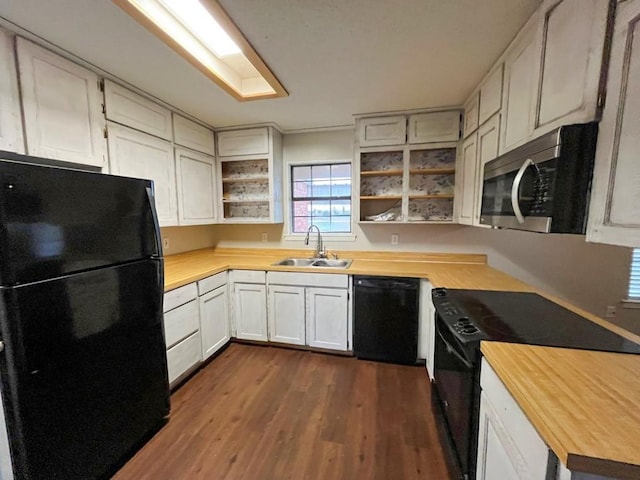 kitchen with wooden counters, dark wood finished floors, open shelves, a sink, and black appliances