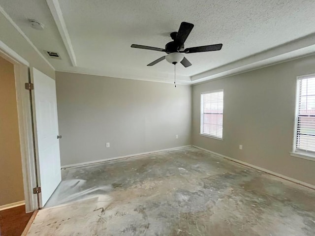 empty room with visible vents, a ceiling fan, unfinished concrete flooring, a textured ceiling, and baseboards