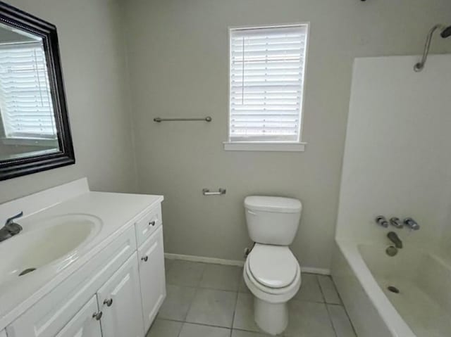 bathroom featuring toilet, tile patterned flooring, tub / shower combination, baseboards, and vanity