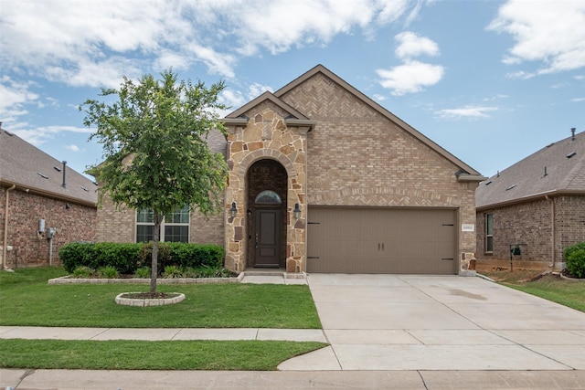 view of front of home with brick siding, a front lawn, concrete driveway, an attached garage, and stone siding