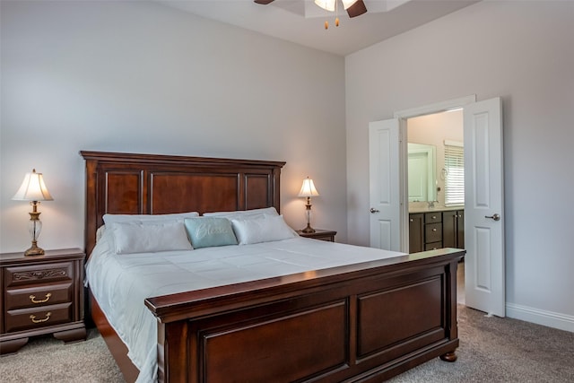 carpeted bedroom featuring baseboards, a ceiling fan, and connected bathroom