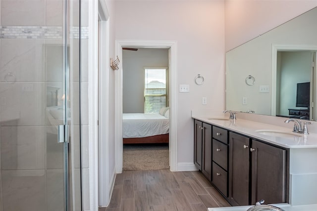 full bathroom with a sink, a stall shower, double vanity, and connected bathroom