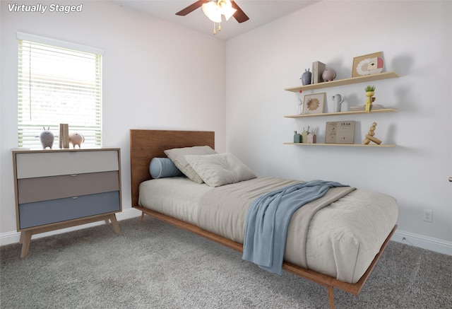 bedroom featuring baseboards, a ceiling fan, and carpet