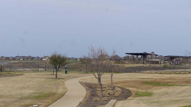 view of property's community with fence and a residential view
