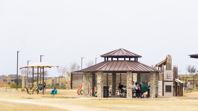 view of property's community with a gazebo, fence, and playground community