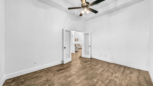 unfurnished bedroom with baseboards, wood finished floors, and a ceiling fan