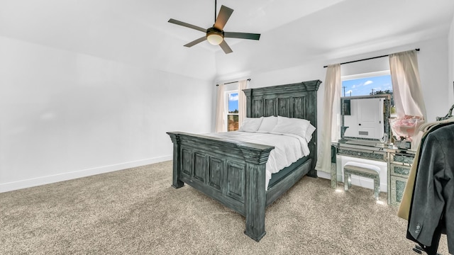 bedroom with baseboards, ceiling fan, and multiple windows