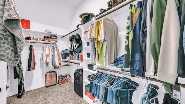 spacious closet with carpet floors and vaulted ceiling