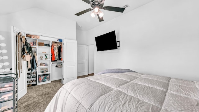 carpeted bedroom with ceiling fan, a closet, and vaulted ceiling