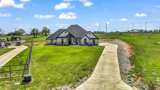 view of front of house with a front lawn and fence