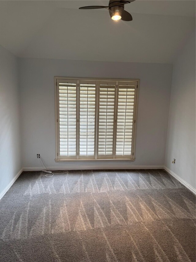 carpeted spare room with baseboards, ceiling fan, and a wealth of natural light