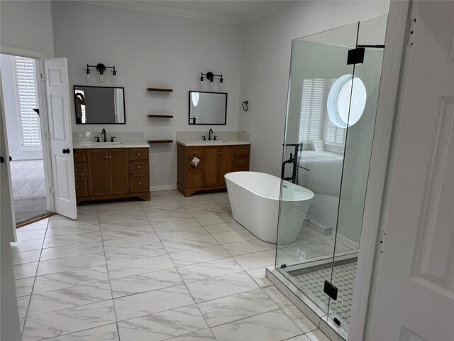 bathroom with a healthy amount of sunlight, crown molding, marble finish floor, and a sink