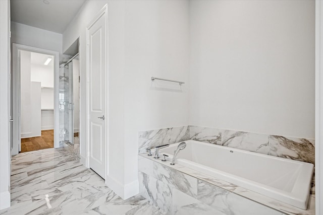 4122 Belt Line Rd, Addison, TX 75001 - bathroom featuring marble look tile flooring, a shower stall, and a garden tub