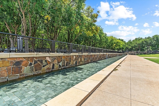 view of home's community featuring fence