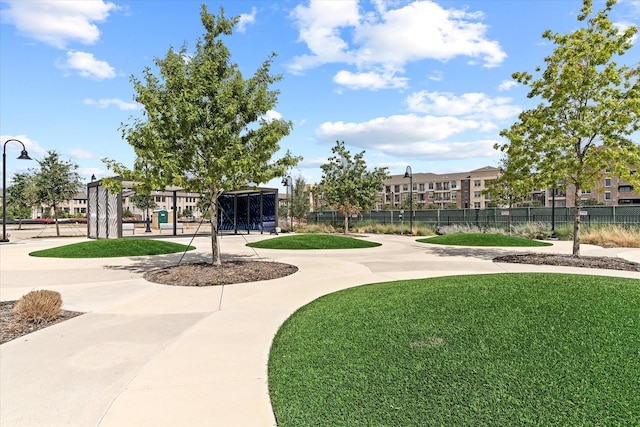 view of community with a yard and fence