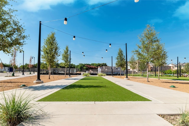 view of community featuring a yard and fence