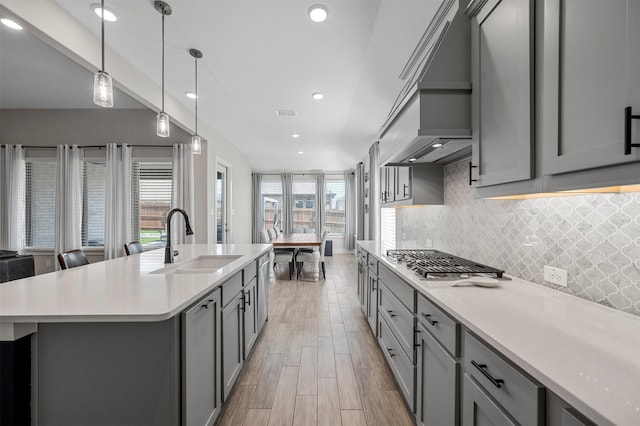 1840 Big Spring Dr, Forney, TX 75126 - kitchen with gray cabinetry, stainless steel gas cooktop, tasteful backsplash, light countertops, and recessed lighting