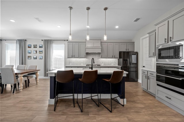1840 Big Spring Dr, Forney, TX 75126 - kitchen featuring black refrigerator with ice dispenser, gray cabinetry, wall oven, built in microwave, and recessed lighting