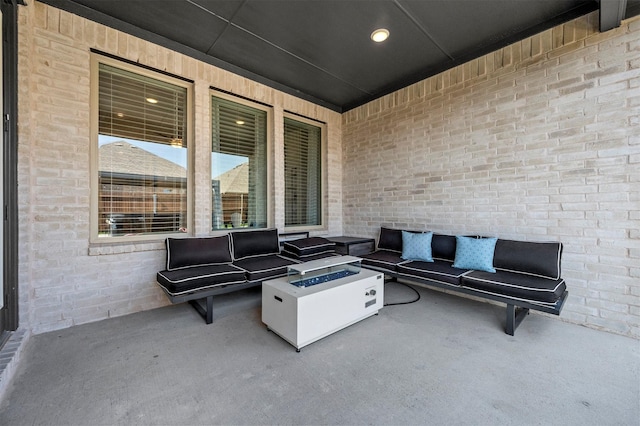 view of patio with an outdoor living space with a fire pit