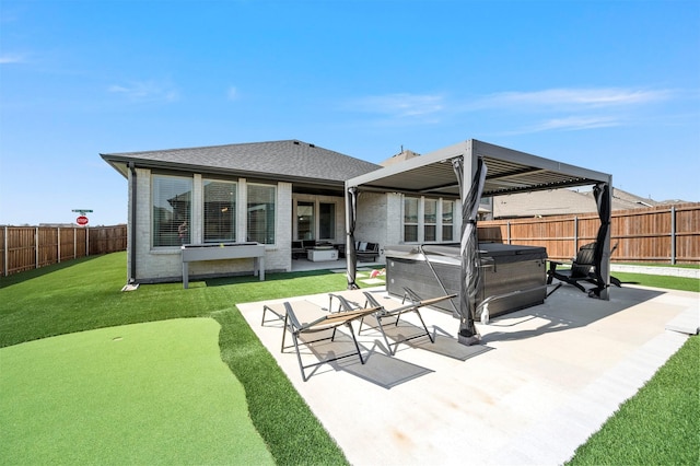 back of house featuring a fenced backyard, a yard, a patio area, brick siding, and a hot tub